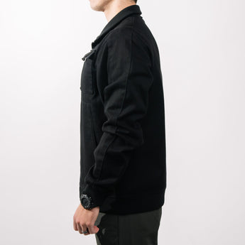 Person wearing a black jacket on a white background