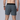 Rear shot of a model wearing dark grey shorts in a studio setting
