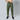 A front view of a person wearing green concealed carry joggers with an inside-the-waistband holstered handgun tucked securely into the waistband.