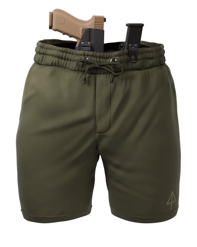 Olive green drawstring shorts with a black holster and tan handgun inserted at the waist, shown on a plain white background.