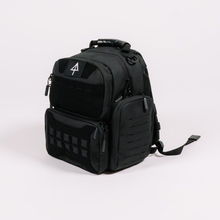 A black tactical backpack with multiple zippered compartments, and a white Arrowhead logo patch attached to the upper front pocket.