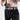 A close-up of a man lifting a grey t-shirt to reveal a grey HC logo belt and a handgun in an appendix holster worn over black Constantine Carry Pants.
