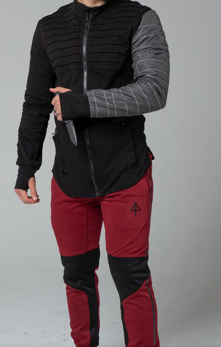 Red joggers front with tactical knife in hand